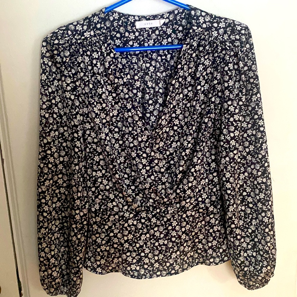 Beautiful floral top with a button to secure plunge neckline